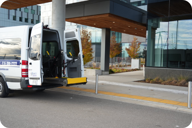 Dignity Transportation white accessible van parked in a Toronto loading zone with ramp deployed