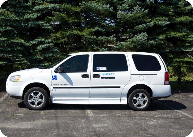 White accessible wheelchair van with ramp deployed at a safe curbside loading zone