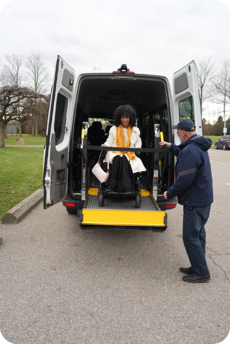 White Dignity Transportation accessible van with side lift ready at a safe curbside loading zone